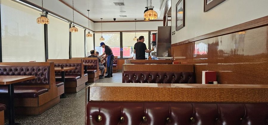 Inside Pete's Blue Chip: red tufted leather booths, wood tables and staff working the counter